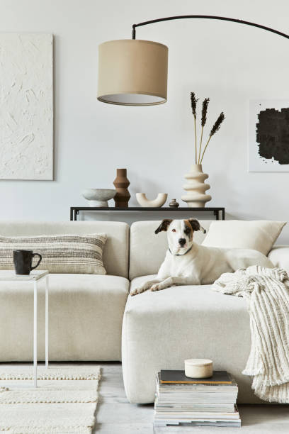 istock Creative interior composition of cozy living room with mock up poster frame and structure painting, corner sofa, coffee table, textile and personal accessories. Scandinavian classic style. 1343267407