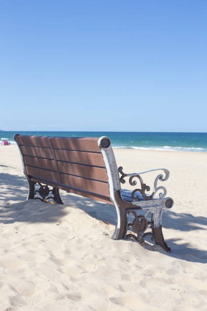 istock wooden bench by the empty sandy beach. 1343267846