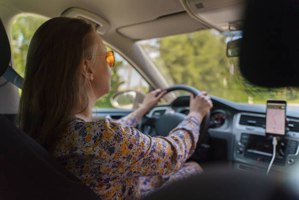istock Woman driving a car in summer time. 1343270170
