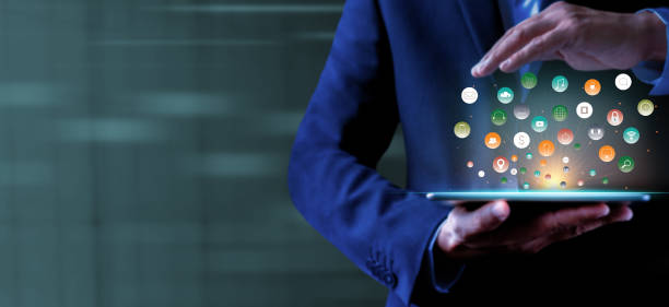 istock Businessman holding tablet showing virtual icons app. 1343271877