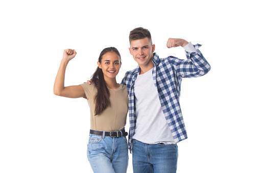 Portrait of a young attractive couple standing isolated over white background, flexing biceps
