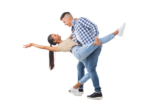 Picture of a young couple dancing isolated over white background