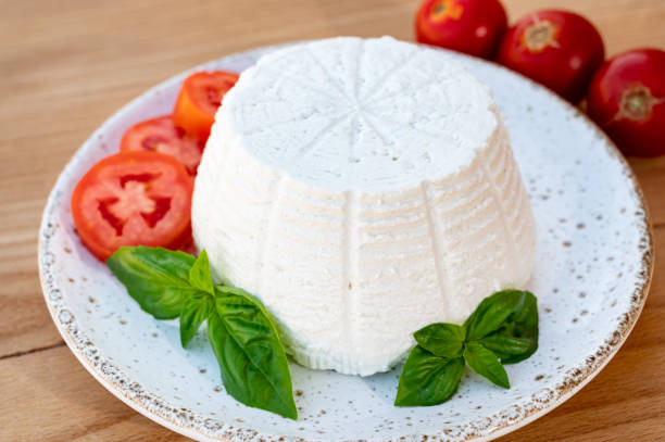istock Cheese collection, white Italian soft cheese ricotta served with fresh tomatoes and basil 1343273560