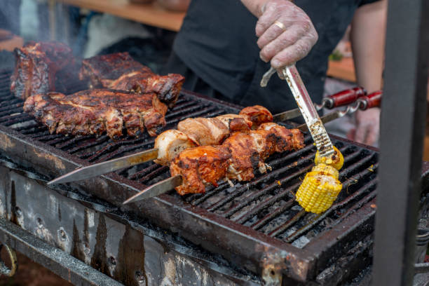 istock The cook grills corn and meat on a spit. BBQ vegetables and meat 1343275258