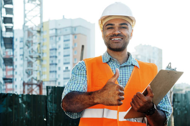 istock Young man engineer in workwear standing in construction site with clipboard 1343275658