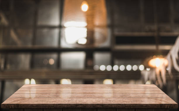 istock Empty wooden table top with lights bokeh on blur restaurant background 1343278032