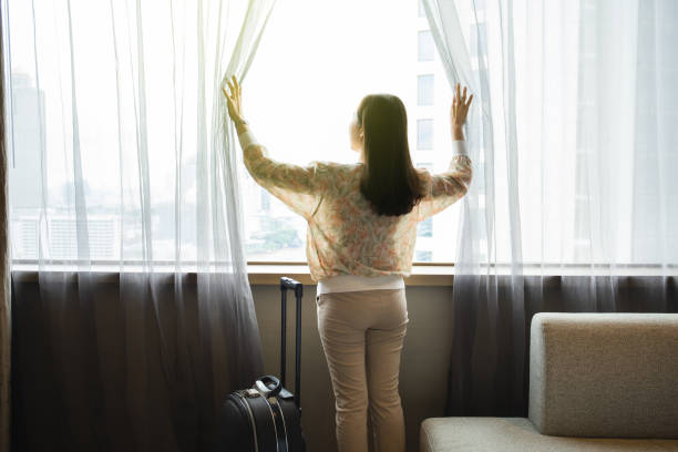 istock Woman opening the window curtain. 1343278477