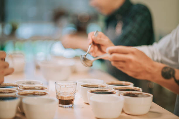 istock close up Asian Chinese barista connoisseur scooping coffee ground cleaning for coffee cupping tasting scope 1343278564