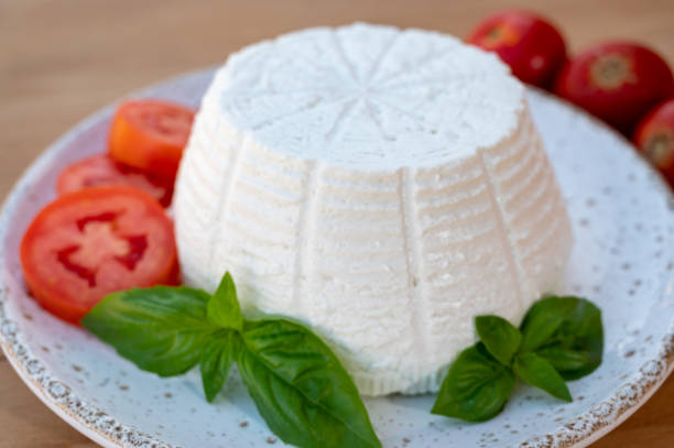 istock Cheese collection, white Italian soft cheese ricotta served with fresh tomatoes and basil 1343280291