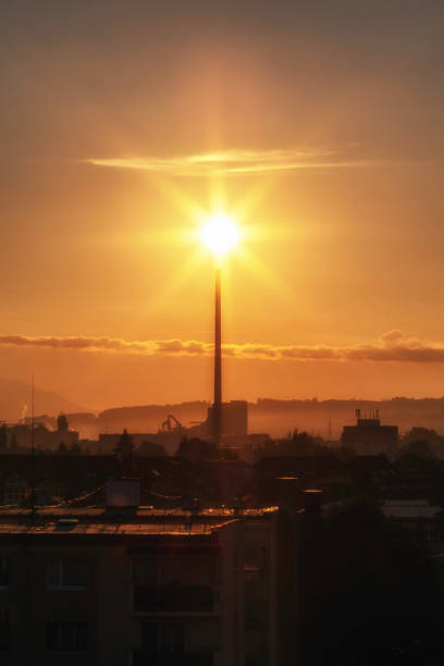 istock Sunshine over smokestack in factory 1343283809