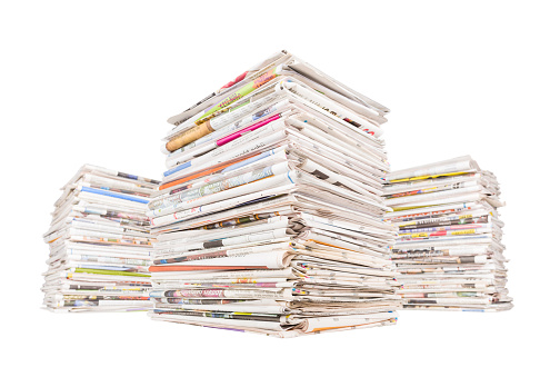 Three big stacks of newspapers isolated on white background. News and updates concept.