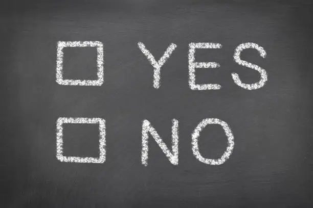 Photo of Yes and no on a chalkboard