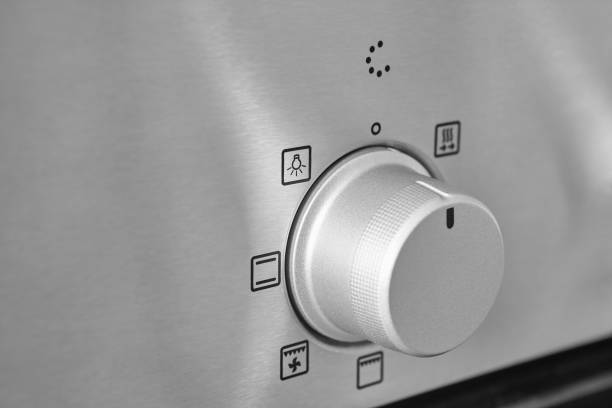 istock Oven cooking temperature control knob. Kitchen equipment panel detail 1343289596