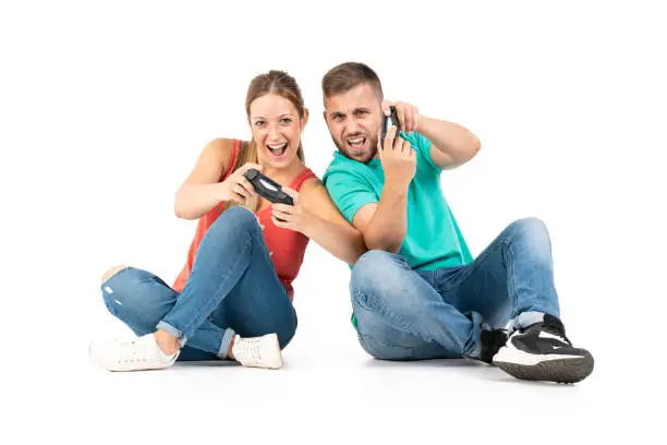 A young couple playing videogames with a controler on a perfect white background