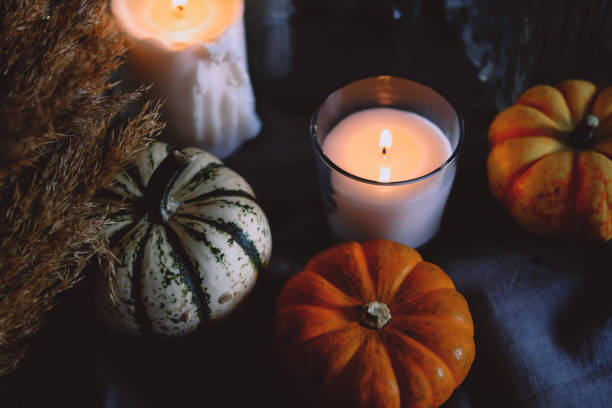 istock Cozy autumn home decor with candles and pumpking. 1343291997