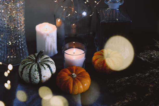 istock Cozy autumn home decor with candles and pumpking. 1343291998