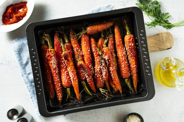 istock young carrots baked with sesame seeds and soy sauce in a baking sheet on the table. spring recipe 1343292067