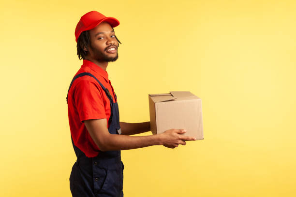 istock Courier holding cardboard parcel, delivering order, shipment and cargo transportation service. 1343292410
