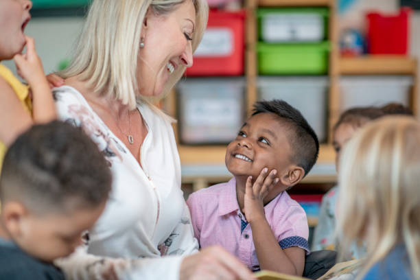 istock Teacher Sitting with Preschool Children 1343292616
