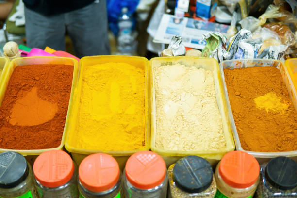 Top view of various Moroccan spices on display at a traditional food market.