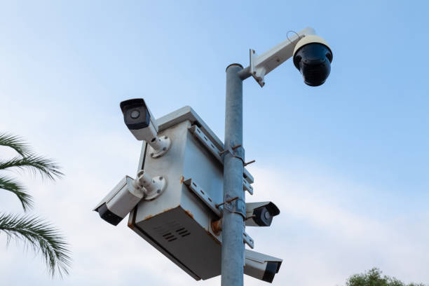 istock CCTV Security camera on the street in the city with sky background. Technology concept 1343296592