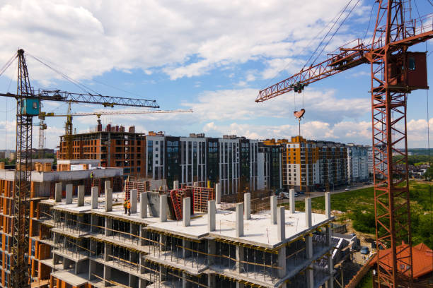 istock Tower crane at high concrete residential building under construction. Real estate development concept. 1343296990