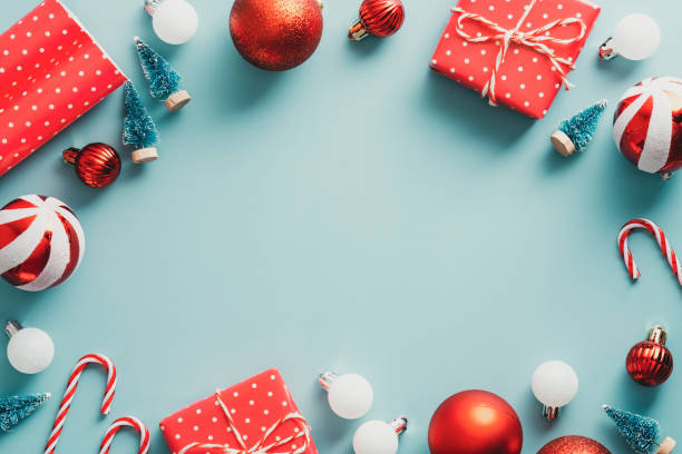 istock Christmas frame with classic decorations. Vintage style. Flat lay, top view red gift boxes, striped balls, Xmas trees. Greeting card design, festive banner mockup 1343297185