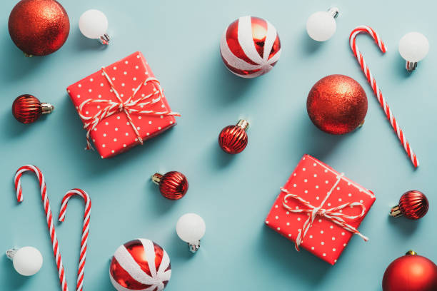 istock Vintage Christmas composition with red gift boxes, stripped balls, candy canes on blue background. Flat lay, top view, overhead. 1343297186