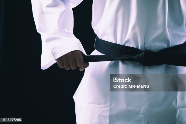 Close Up Taekwondo Martial Arts Fighter In White Uniform Holding Black Belt Stock Photo - Download Image Now