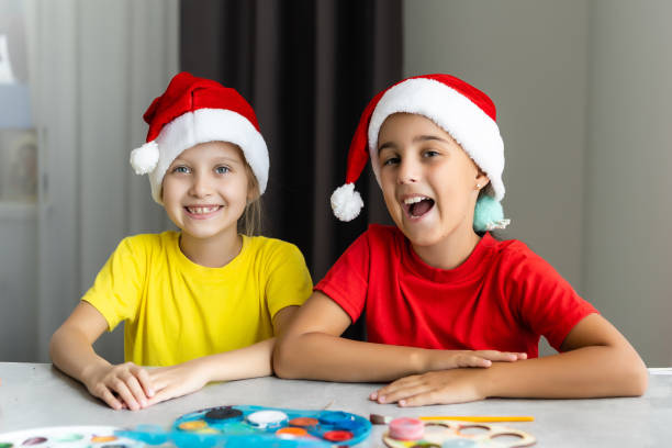 istock Two little sisters having fun while making christmas Nativity crafts with at home 1343297250