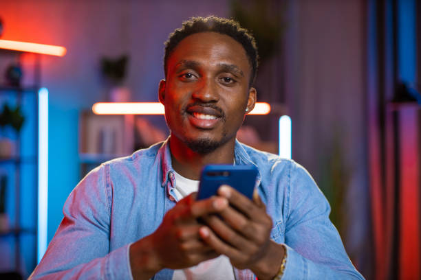 istock Portrait of african man using smartphone at home 1343297460