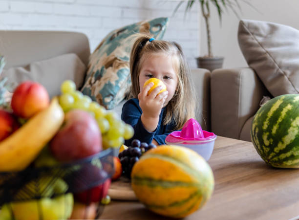 istock Little girl making fresh fruit juice 1343298205