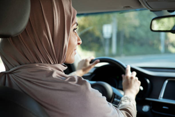 istock Woman In Hijab Driving Car 1343299878