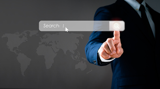 The search bar is pointed to by a man in a suit. Search engine optimization (SEO) networking is a concept. You can search the Internet Data Information Browser with a blank search bar.