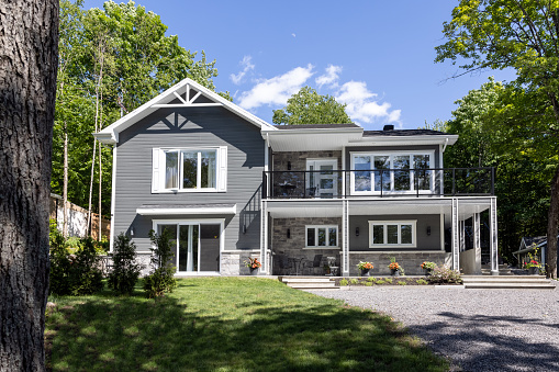 Luxurious gray and white property located in Quebec, Canada on a sunny day of summer.