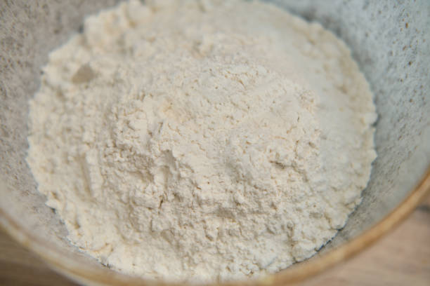 istock Flour in a white ceramic bowl, close - up view from above 1343303601