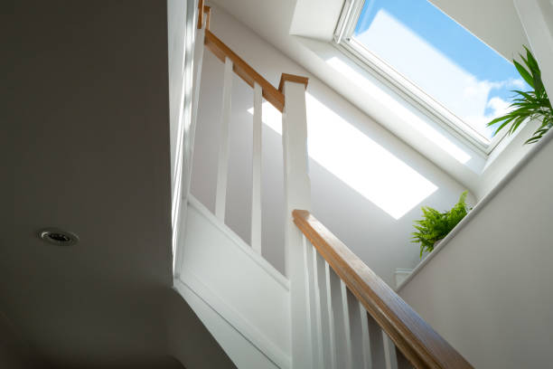 Abstract view of a newly installed loft conversion seen from the ground floor, looking at the staircase.
