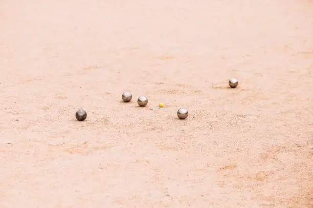 Metal petanque balls on the court during the game - the process of scoring