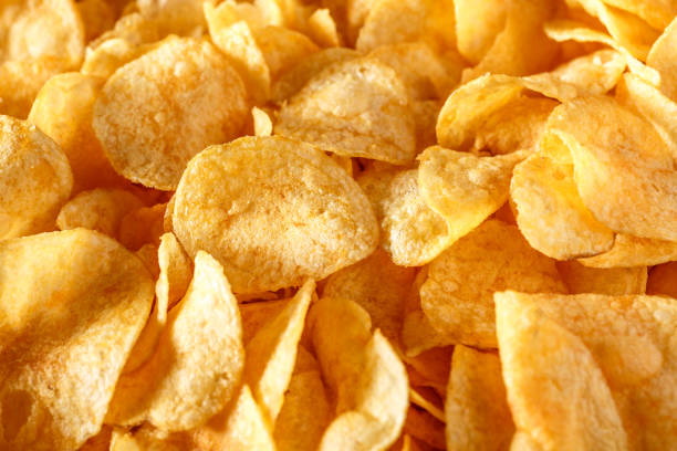 istock Potato chips or crisps .Potato chips texture background flat overhead view.concept of fast food and snacks. Food background. 1343304890