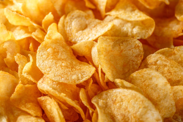 istock Potato chips or crisps .Potato chips texture background flat overhead view.concept of fast food and snacks. Food background. 1343304911