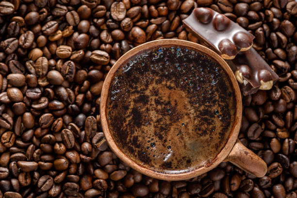 istock Coffee with milk cup and roasted beans.Coffee beans wallpaper. Coffee background. Side view. 1343305083