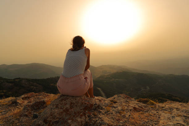 istock Woman alone contemplating sunset in the mountain 1343306548