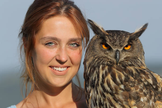 istock Happy woman holding royal owl looking at camera 1343306587