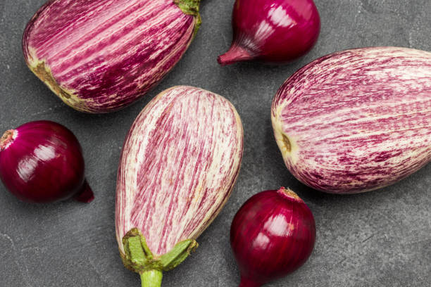 istock Striped eggplants and blue onions. 1343307479