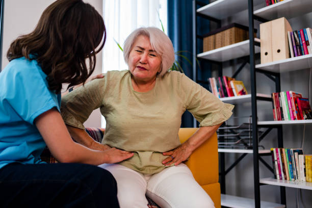 Abdominal pain patient woman having medical exam with doctor on illness from stomach cancer, irritable bowel syndrome, pelvic discomfort, Indigestion, Diarrhea, GERD (gastro-esophageal reflux disease) stock photo