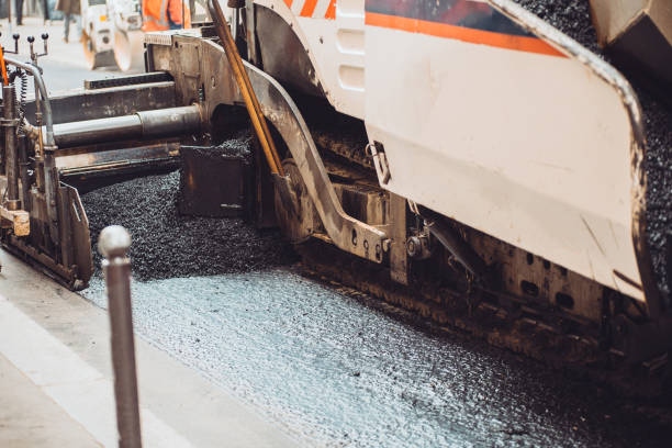 istock Asphalt laying on a city street 1343309987