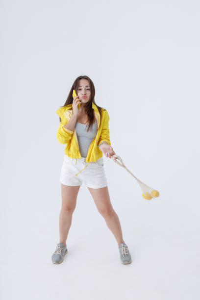 istock Cute young woman talking on cellphone in studio 1343311429