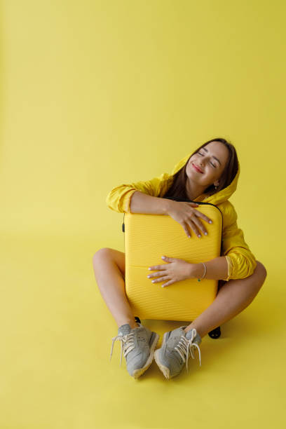 istock Cheerful young woman hugging travel bag in studio 1343311431