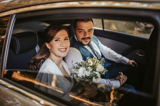 the bride and groom under the veil on the sunset by the river. the concept of romance and a beautiful wedding ceremony.