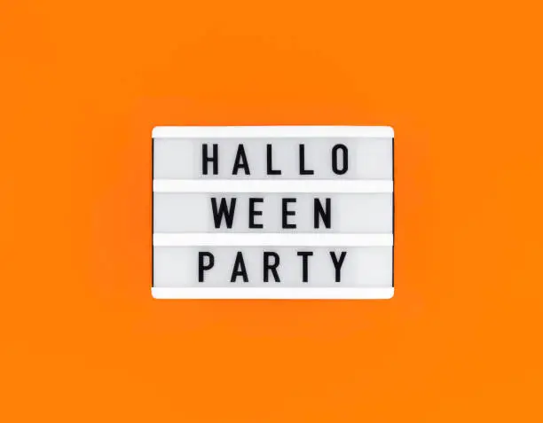 Photo of Light box with Halloween party text on orange background.